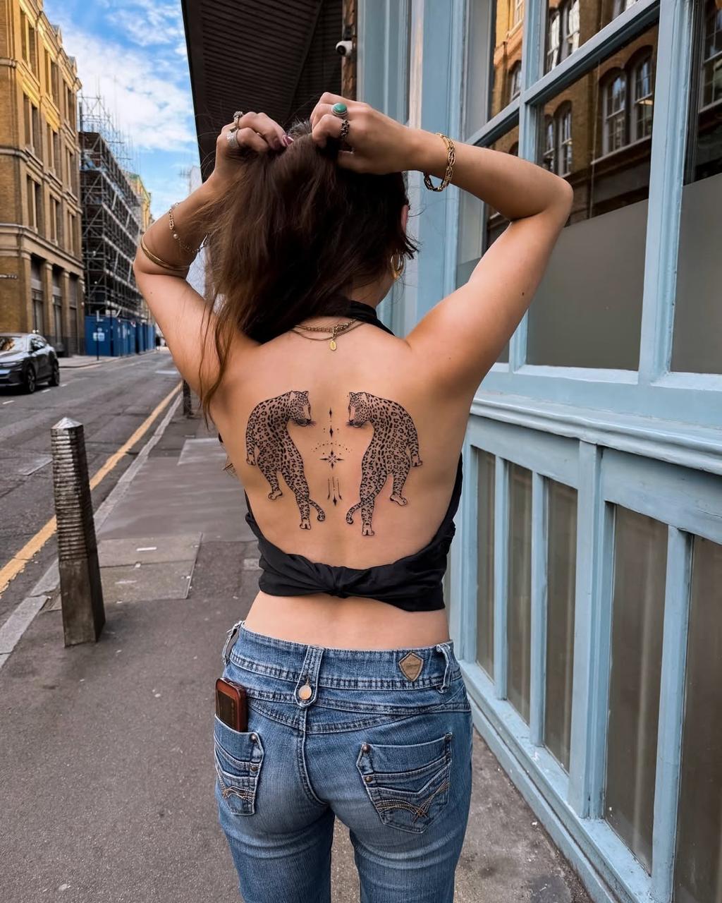 Feminine back piece tattoos